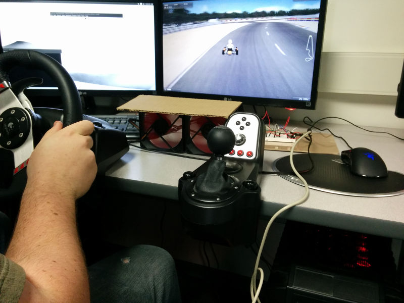 A participant playing a racing game
                with simulated physical wind